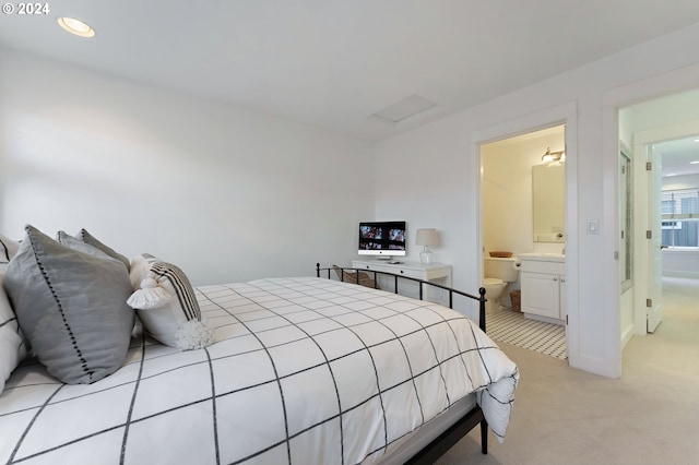 carpeted bedroom featuring ensuite bathroom