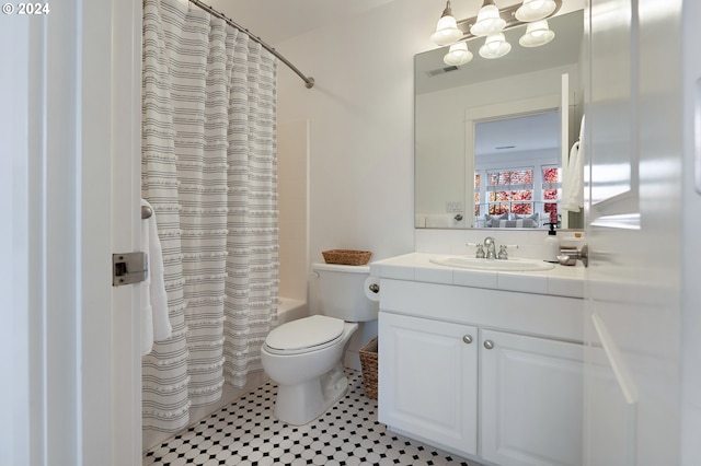 full bathroom with vanity, tile patterned flooring, toilet, and shower / tub combo