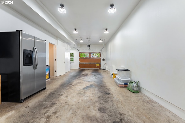 garage with stainless steel refrigerator with ice dispenser