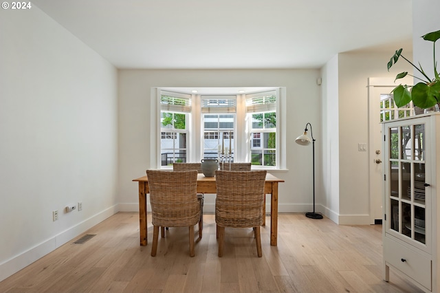 dining space with light hardwood / wood-style flooring