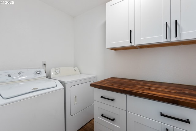 washroom featuring cabinets and separate washer and dryer