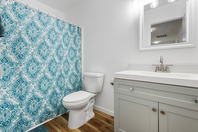 bathroom with hardwood / wood-style floors, vanity, and toilet