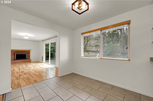 unfurnished living room with a fireplace and light hardwood / wood-style flooring