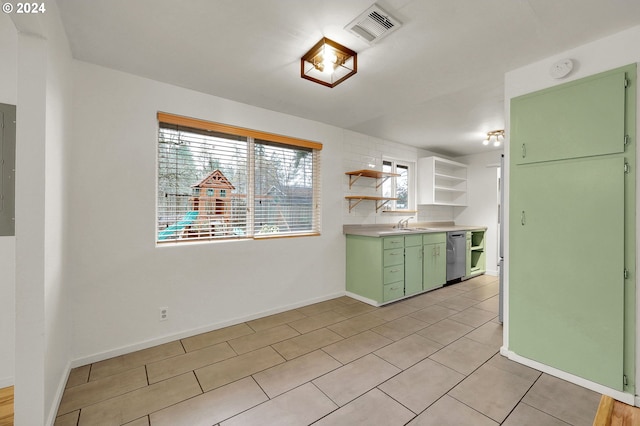 kitchen with sink, dishwasher, electric panel, light tile patterned floors, and green cabinetry