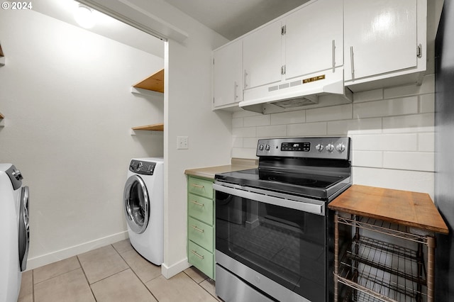 kitchen with decorative backsplash, light tile patterned floors, electric range, and white cabinetry