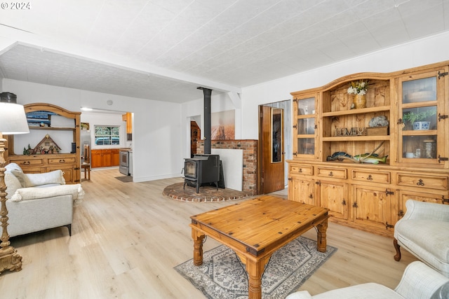 living room featuring light wood-type flooring and a wood stove