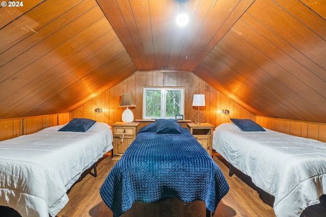 bedroom with wood walls, wood ceiling, and light hardwood / wood-style flooring