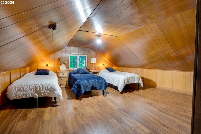 bedroom with vaulted ceiling, light hardwood / wood-style flooring, wooden walls, and wood ceiling