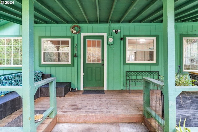 view of exterior entry featuring covered porch