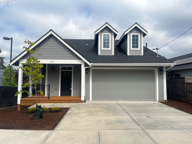 view of front of house with covered porch and a garage