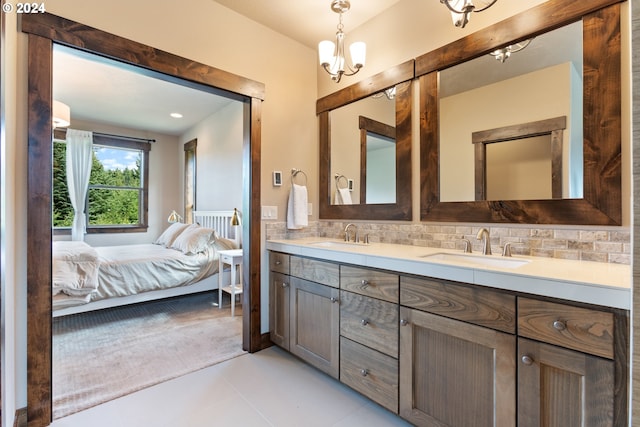 bathroom with tile patterned flooring, decorative backsplash, vanity, and a notable chandelier