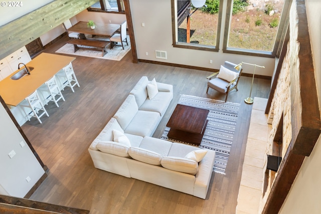 living room with hardwood / wood-style floors and sink