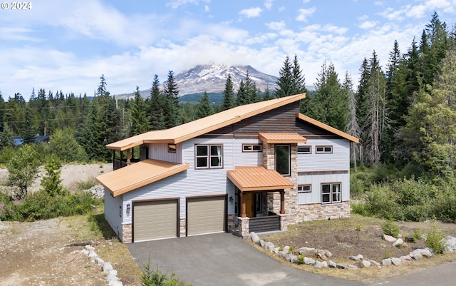 view of front of home featuring a mountain view and a garage