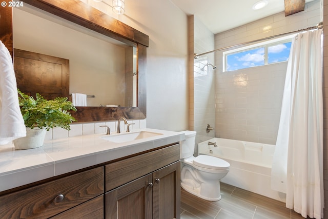 full bathroom featuring shower / bath combo, toilet, and vanity