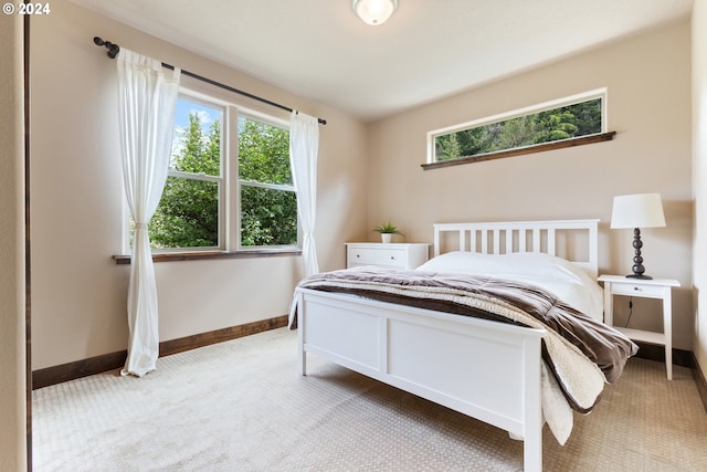 bedroom featuring light colored carpet