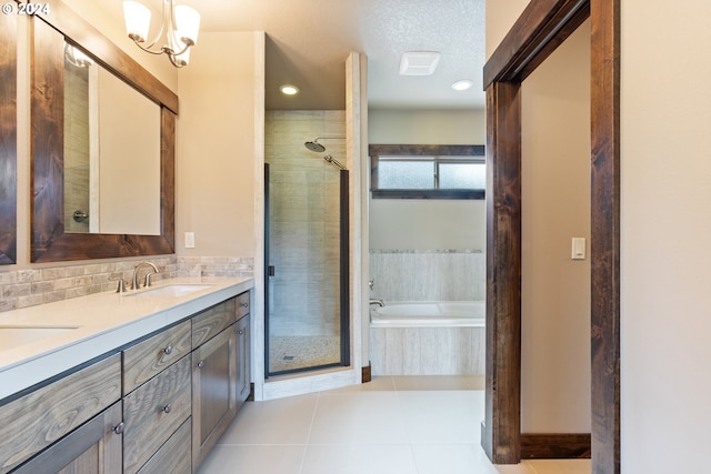 bathroom featuring vanity, a textured ceiling, an inviting chandelier, tile patterned flooring, and shower with separate bathtub