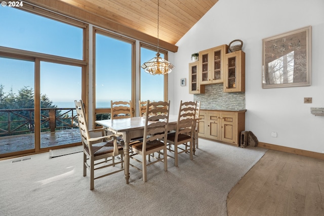 79274 Ray Brown Rd, Arch Cape, OR 97102 - dining area with wooden ceiling, high vaulted ceiling, a water view, light wood-type flooring, and a chandelier