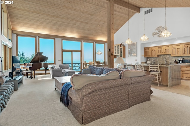 79274 Ray Brown Rd, Arch Cape, OR 97102 - carpeted living room featuring plenty of natural light, wood ceiling, and high vaulted ceiling