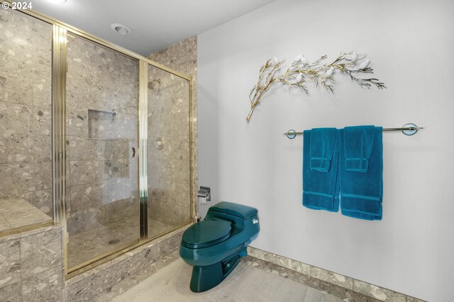 79274 Ray Brown Rd, Arch Cape, OR 97102 - bathroom featuring tile patterned flooring, a shower with shower door, and toilet