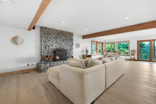 79274 Ray Brown Rd, Arch Cape, OR 97102 - living room featuring a fireplace, light hardwood / wood-style floors, and beam ceiling