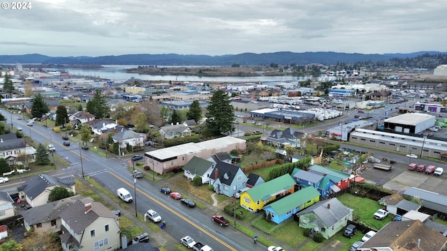 drone / aerial view featuring a water and mountain view