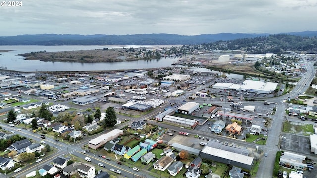 drone / aerial view with a water and mountain view