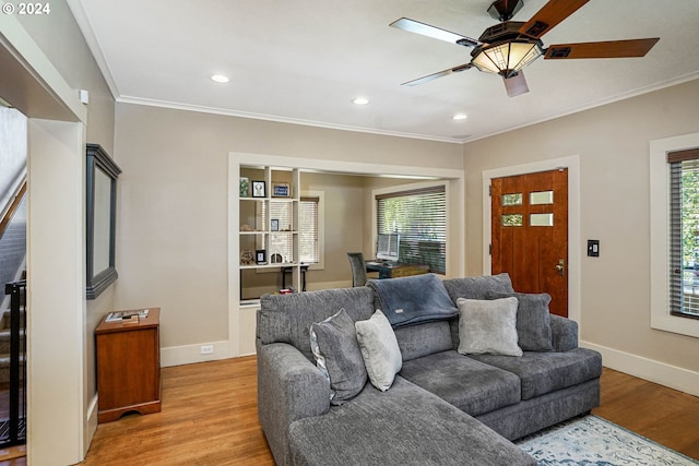 living room featuring ornamental molding, ceiling fan, and light hardwood / wood-style floors