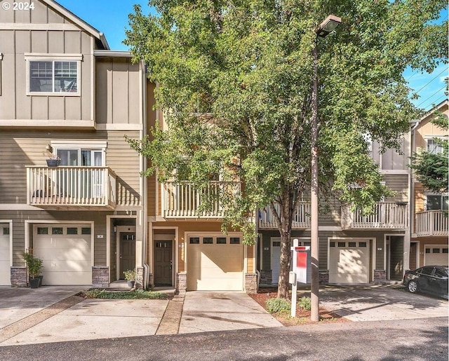 multi unit property with a garage and a balcony