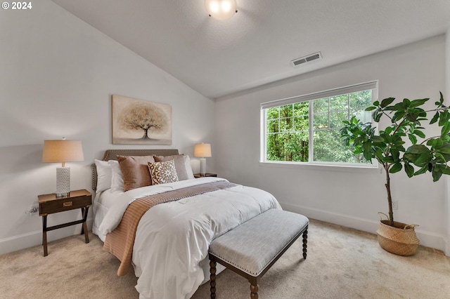 carpeted bedroom featuring lofted ceiling