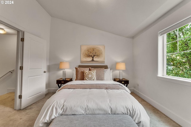 carpeted bedroom featuring lofted ceiling