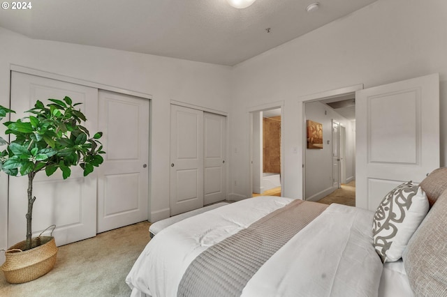 carpeted bedroom with vaulted ceiling