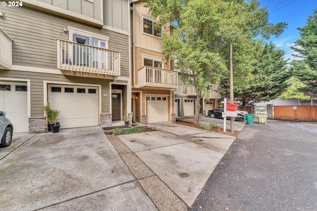 view of property featuring a balcony and a garage