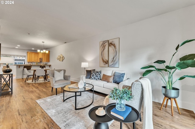 living room featuring light hardwood / wood-style floors and a chandelier