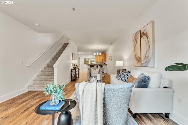 living room featuring light hardwood / wood-style flooring and a chandelier