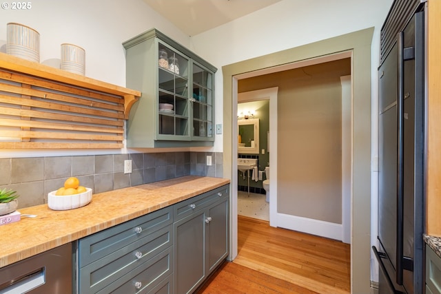 kitchen featuring tasteful backsplash and light hardwood / wood-style floors