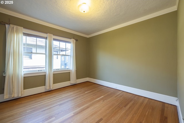 unfurnished room featuring ornamental molding, a textured ceiling, and light wood-type flooring