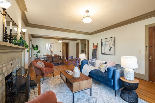 living room with ornamental molding, a fireplace, and light hardwood / wood-style floors