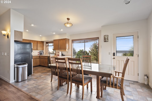 dining area featuring a healthy amount of sunlight and lofted ceiling