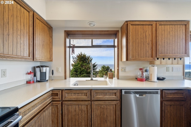 kitchen featuring dishwasher, sink, and range with electric cooktop