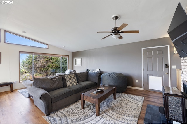 living room featuring lofted ceiling, hardwood / wood-style floors, and ceiling fan