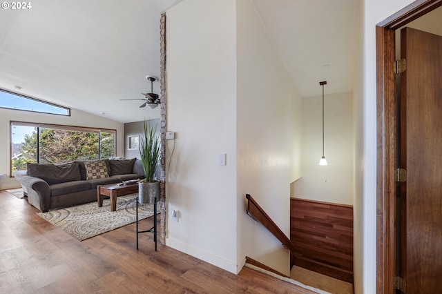 living room with lofted ceiling, hardwood / wood-style floors, and ceiling fan