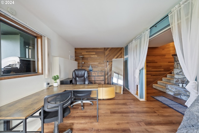 office area featuring wooden walls and hardwood / wood-style floors