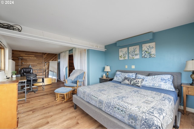 bedroom featuring wood walls and hardwood / wood-style floors