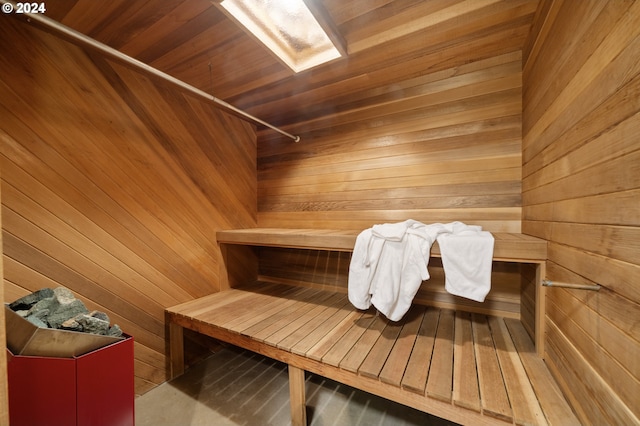 view of sauna with wooden walls and wood ceiling