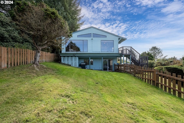 rear view of property with a lawn