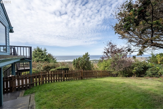 view of yard with a deck with water view