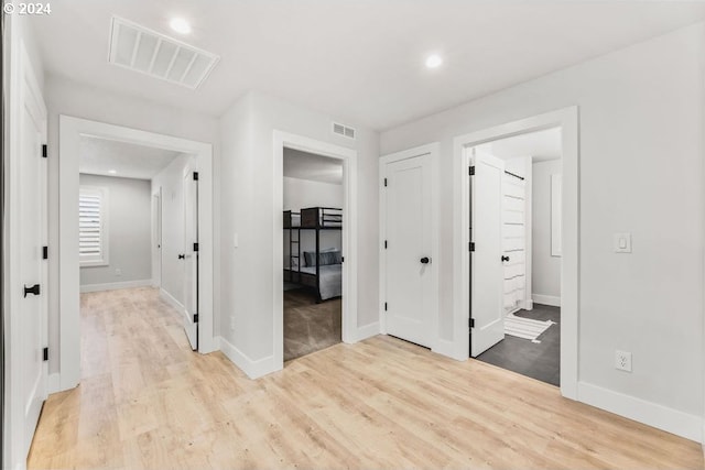 hall with light hardwood / wood-style floors