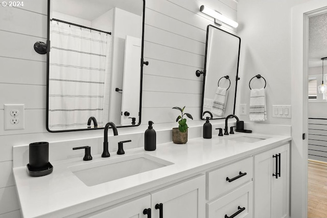 bathroom featuring double sink, hardwood / wood-style floors, and large vanity