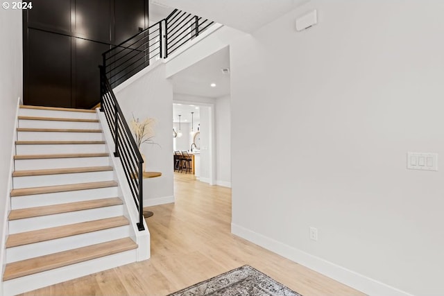 stairs featuring light wood-type flooring