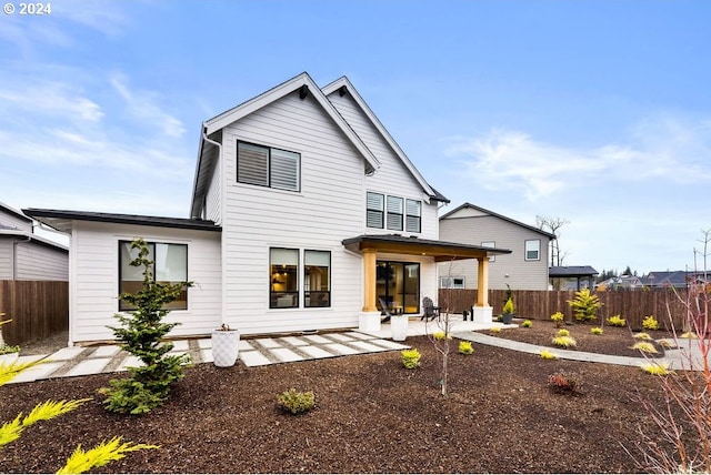 rear view of property featuring a patio area